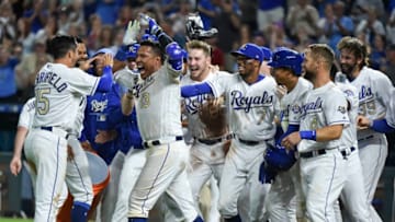 KANSAS CITY, MO - SEPTEMBER 14: Salvador Perez #13 celebrates with Whit Merrifield #15 and members of the Kansas City Royals as he celebrates his walk-off grand slam against the Minnesota Twins in the ninth inning at Kauffman Stadium on September 14, 2018 in Kansas City, Missouri. (Photo by Ed Zurga/Getty Images)