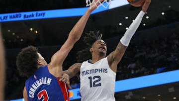 Memphis Grizzles guard Ja Morant (12) shoots as Detroit Pistons guard Cade Cunningham (2) defends Credit: Petre Thomas-USA TODAY Sports