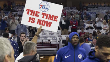 PHILADELPHIA, PA - OCTOBER 20: Joel Embiid #21 of the Philadelphia 76ers walks onto the court as a fan holds up a sign prior to the game against the Boston Celtics at the Wells Fargo Center on October 20, 2017 in Philadelphia, Pennsylvania. NOTE TO USER: User expressly acknowledges and agrees that, by downloading and or using this photograph, User is consenting to the terms and conditions of the Getty Images License Agreement. (Photo by Mitchell Leff/Getty Images)
