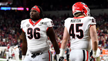 Zion Logue and Bill Norton warm up prior to a game against the Alabama Crimson Tide in the 2022 CFP National Championship Game. (Photo by Emilee Chinn/Getty Images)
