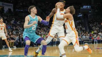 Mar 16, 2022; Charlotte, North Carolina, USA; Atlanta Hawks guard Trae Young (11) drives to the basket defended by Charlotte Hornets guard LaMelo Ball (2) during the first quarter at the Spectrum Center. Mandatory Credit: Jim Dedmon-USA TODAY Sports