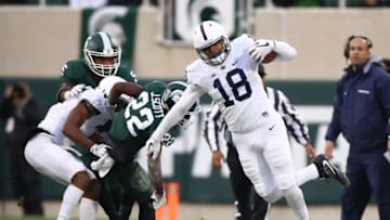 EAST LANSING, MI - NOVEMBER 04: Jonathan Holland #18 of the Penn State Nittany Lions tries for extra yards before going out of bounds while playing the Michigan State Spartans at Spartan Stadium on November 4, 2017 in East Lansing, Michigan. (Photo by Gregory Shamus/Getty Images)