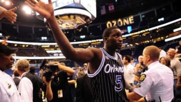 Feb 21, 2014; Orlando, FL, USA; Orlando Magic shooting guard Victor Oladipo (5) high fives a fan as he walks off the court as the Orlando Magic beat the New York Knicks 129-121 in double overtime at Amway Center. Oladipo finished with 30 points including a key dunk with 30 seconds to go in overtime. Mandatory Credit: David Manning-USA TODAY Sports