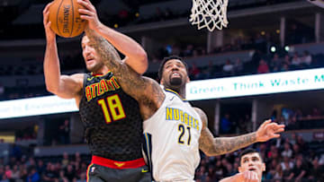 DENVER, CO - JANUARY 10: Miles Plumlee #18 of the Atlanta Hawks rebounds the ball over Wilson Chandler #21 of the Denver Nuggets at the Pepsi Center on January 10, 2018 in Denver, Colorado. NOTE TO USER: User expressly acknowledges and agrees that, by downloading and or using this photograph, User is consenting to the terms and conditions of the Getty Images License Agreement. (Photo by Timothy Nwachukwu/Getty Images)