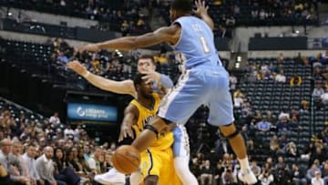 Nov 14, 2014; Indianapolis, IN, USA; Indiana Pacers forward Solomon Hill (44) makes a pass against Denver Nuggets forward Alonzo Gee (1) and center Jusuf Nurkic (23) at Bankers Life Fieldhouse. Denver defeats Indiana 108-87. Mandatory Credit: Brian Spurlock-USA TODAY Sports