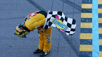 PHOENIX, AZ - NOVEMBER 11: Kyle Busch, driver of the #18 M&M's Toyota, celebrates with the checkered flag after winning the Monster Energy NASCAR Cup Series Can-Am 500 at ISM Raceway on November 11, 2018 in Phoenix, Arizona. (Photo by Sarah Crabill/Getty Images)