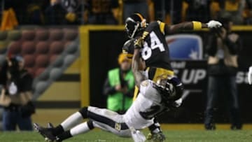 Nov 2, 2014; Pittsburgh, PA, USA; Pittsburgh Steelers wide receiver Antonio Brown (84) is tackled by Baltimore Ravens cornerback Lardarius Webb (21) during the first half of the game at Heinz Field. Mandatory Credit: Jason Bridge-USA TODAY Sports