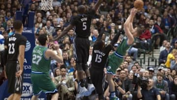Jan 20, 2016; Dallas, TX, USA; Dallas Mavericks forward Chandler Parsons (25) shoots over Minnesota Timberwolves forward Shabazz Muhammad (15) and center Gorgui Dieng (5) during the second half at the American Airlines Center. The Mavericks defeat the Timberwolves 106-94. Mandatory Credit: Jerome Miron-USA TODAY Sports