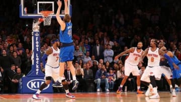 Feb 24, 2014; New York, NY, USA; Dallas Mavericks power forward Dirk Nowitzki (41) shoots the game winning shot over New York Knicks small forward Carmelo Anthony (7) at Madison Square Garden. Dallas Mavericks won 110-108. Mandatory Credit: Anthony Gruppuso-USA TODAY Sports