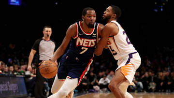 NEW YORK, NEW YORK - NOVEMBER 27: Kevin Durant #7 of the Brooklyn Nets heads for the net as Mikal Bridges #25 of the Phoenix Suns defends at Barclays Center on November 27, 2021 in New York City. The Phoenix Suns defeated the Brooklyn Nets 113-107. NOTE TO USER: User expressly acknowledges and agrees that, by downloading and or using this photograph, User is consenting to the terms and conditions of the Getty Images License Agreement. (Photo by Elsa/Getty Images)