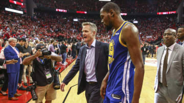May 6, 2019; Houston, TX, USA; Golden State Warriors head coach Steve Kerr (center) and forward Kevin Durant (35) walk off the court after game four of the second round of the 2019 NBA Playoffs against the Houston Rockets at Toyota Center. Mandatory Credit: Troy Taormina-USA TODAY Sports