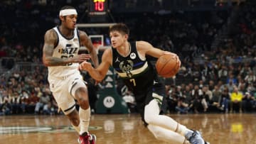 Oct 31, 2021; Milwaukee, Wisconsin, USA; Milwaukee Bucks guard Grayson Allen (7) drives for the basket around Utah Jazz guard Jordan Clarkson (00) during the second quarter at Fiserv Forum. Mandatory Credit: Jeff Hanisch-USA TODAY Sports