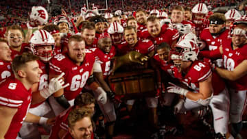 Nov 9, 2019; Madison, WI, USA; Wisconsin Badgers players celebrate with the Heartland Trophy following the game against the Iowa Hawkeyes at Camp Randall Stadium. Mandatory Credit: Jeff Hanisch-USA TODAY Sports