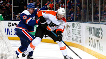 UNIONDALE, NEW YORK - OCTOBER 27: Kevin Hayes #13 of the Philadelphia Flyers is defended by Devon Toews #25 of the New York Islanders during the second period at NYCB Live's Nassau Coliseum on October 27, 2019 in Uniondale, New York. (Photo by Mike Stobe/NHLI via Getty Images)