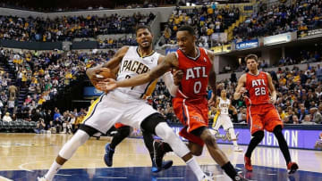 Feb 18, 2014; Indianapolis, IN, USA; Indiana Pacers forward Paul George (24) drives to the basket and gets fouled by Atlanta Hawks guard Jeff Teague (0) at Bankers Life Fieldhouse. Indiana defeats Atlanta 108-98. Mandatory Credit: Brian Spurlock-USA TODAY Sports