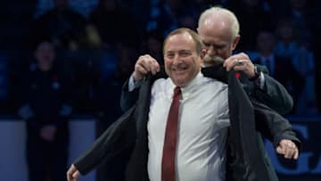 TORONTO, ON - NOVEMBER 11: HHOF Chairman Lanny McDonald helps NHL Commissioner, Inductee Gary Bettman with his jacket. The annual Hockey Hall of Fame Legends Classic pitting Team (Ed) Belfour against Team (Grant) Fuhr at Scotiabank Arena. All part of the weekend HHOF celebrations. Toronto Star/Rick Madonik (Rick Madonik/Toronto Star via Getty Images)