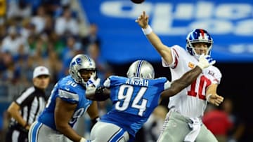 Sep 8, 2014; Detroit, MI, USA; New York Giants quarterback Eli Manning (10) is pressured by Detroit Lions defensive end Ezekiel Ansah (94) during the second quarter at Ford Field. Mandatory Credit: Andrew Weber-USA TODAY Sports