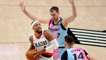 PORTLAND, OREGON - APRIL 11: Damian Lillard #0 of the Portland Trail Blazers works towards the basket against Goran Dragic #7 and Tyler Herro #14 of the Miami Heat in the third quarter at Moda Center on April 11, 2021 in Portland, Oregon. NOTE TO USER: User expressly acknowledges and agrees that, by downloading and or using this photograph, User is consenting to the terms and conditions of the Getty Images License Agreement. (Photo by Abbie Parr/Getty Images)