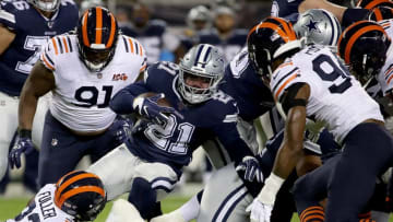 CHICAGO, ILLINOIS - DECEMBER 05: Running back Ezekiel Elliott #21 of the Dallas Cowboys carries the ball against the defense of the Chicago Bears during the game at Soldier Field on December 05, 2019 in Chicago, Illinois. (Photo by Jonathan Daniel/Getty Images)