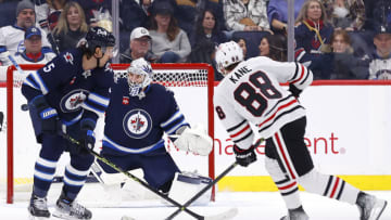 Feb 11, 2023; Winnipeg, Manitoba, CAN; Chicago Blackhawks right wing Patrick Kane (88) shoots wide of Winnipeg Jets goaltender Connor Hellebuyck (37) in the second period at Canada Life Centre. Mandatory Credit: James Carey Lauder-USA TODAY Sports