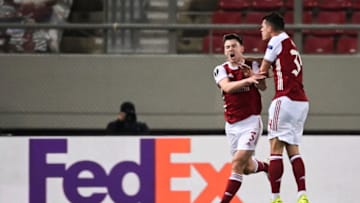 Arsenal's Scottish defender Kieran Tierney (L) celebrates after scoring a goal during the UEFA Europa League 32 Second Leg football match between Arsenal and Benfica at the Karaiskaki Stadium in Athens, on February 25, 2021. (Photo by ARIS MESSINIS / AFP) (Photo by ARIS MESSINIS/AFP via Getty Images)