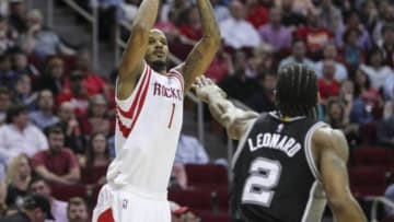 Apr 10, 2015; Houston, TX, USA; Houston Rockets forward Trevor Ariza (1) shoots the ball as San Antonio Spurs forward Kawhi Leonard (2) defends during the second half at Toyota Center. The Spurs won 104-103. Mandatory Credit: Troy Taormina-USA TODAY Sports