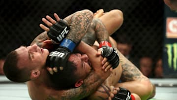 LOS ANGELES, CA - AUGUST 04: Renato Moicano puts Cub Swanson in a choke hold in the first round of the featherweight bout during UFC 227 at Staples Center on August 4, 2018 in Los Angeles, United States. (Photo by Joe Scarnici/Getty Images)