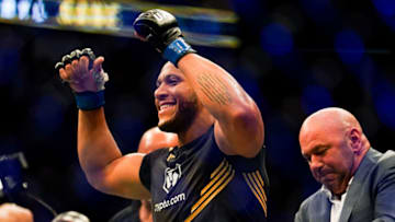HOUSTON, TX - AUGUST 07: Joe Rogan puts the interim heavyweight title belt on Ciryl Gane after defeating Derrick Lewis in the third round of their Heavyweight bout at Toyota Center on July 7, 2021 in Houston, Texas. (Photo by Alex Bierens de Haan/Getty Images )