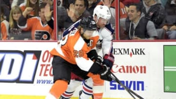 Nov 14, 2014; Philadelphia, PA, USA; Philadelphia Flyers center Claude Giroux (28) and Columbus Blue Jackets left wing Scott Hartnell (43) battle along the boards for the puck during the third period at Wells Fargo Center. The Blue Jackets defeated the Flyers, 4-3. Mandatory Credit: Eric Hartline-USA TODAY Sports