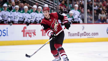 Feb 18, 2016; Glendale, AZ, USA; Arizona Coyotes defenseman Michael Stone (26) passes the puck during the second period against the Dallas Stars at Gila River Arena. Mandatory Credit: Matt Kartozian-USA TODAY Sports