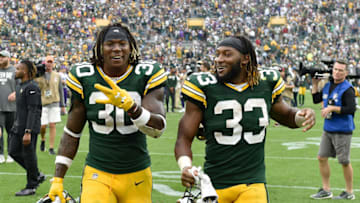 GREEN BAY, WISCONSIN - SEPTEMBER 15: Jamaal Williams #30 and Aaron Jones #33 of the Green Bay Packers celebrate the win against the Minnesota Vikings at Lambeau Field on September 15, 2019 in Green Bay, Wisconsin. (Photo by Quinn Harris/Getty Images)