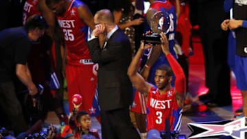 Feb 17, 2013; Houston, TX, USA; Western Conference guard Chris Paul (3) of the Los Angeles Clippers holds the MVP trophy as he son Chris Paul holds a ball after the 2013 NBA All-Star Game at the Toyota Center. Mandatory Credit: Brett Davis-USA TODAY Sports
