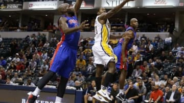 Oct 13, 2015; Indianapolis, IN, USA; Indiana Pacers guard Toney Douglas (23) takes a shot against Detroit Pistons center Joel Anthony (50) and guard Jodie Meeks (20) at Bankers Life Fieldhouse. Indiana defeats Detroit 101-97. Mandatory Credit: Brian Spurlock-USA TODAY Sports