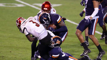 CHARLOTTESVILLE, VA - NOVEMBER 14: DAngelo Amos #30 and Nick Grant #1 of the Virginia Cavaliers force a fumble by Malik Cunningham #3 of the Louisville Cardinals in the second half during a game at Scott Stadium on November 14, 2020 in Charlottesville, Virginia. (Photo by Ryan M. Kelly/Getty Images)
