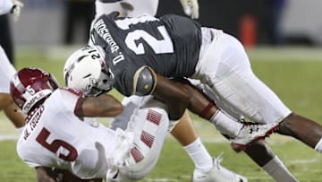 UCF defensive back Drico Johnson (21) puts a hard hit on Temple running back Jahad Thomas (5) at Bright House Networks Stadium in Orlando, Fla., on Saturday, Oct. 15, 2016. (Stephen M. Dowell/Orlando Sentinel/TNS via Getty Images)