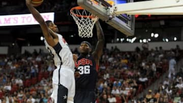 Jul 25, 2013; Las Vegas, NV, USA; USA White Team guard Paul George pulls down a defensive rebound away from USA Blue Team center DeMarcus Cousins during the 2013 USA Basketball Showcase at the Thomas and Mack Center. Mandatory Credit: Stephen R. Sylvanie-USA TODAY Sports