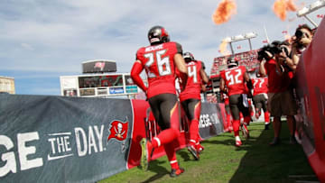 Dec 27, 2015; Tampa, FL, USA; Tampa Bay Buccaneers cornerback Sterling Moore (26) and teammates runs out of the tunnel before the game against the Chicago Bears during the first quarter at Raymond James Stadium. Mandatory Credit: Kim Klement-USA TODAY Sports