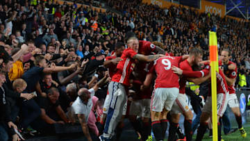 HULL, ENGLAND - AUGUST 27: Manchester United fans break an advertising hoarding as they celebrate Marcus Rashford's last minute winner with the Manchester United team, during the Premier League match between Manchester United FC and Hull City FC at KC Stadium on August 27, 2016 in Hull, England. (Photo by Mark Runnacles/Getty Images) *** Local Caption ***