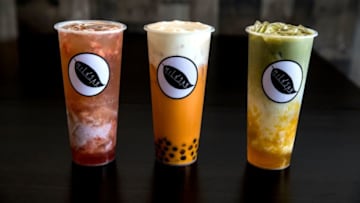 Strawberry jasmine fruit tea with taro pudding, left, Thai tea topped with layer of cheesecake and boba and mango matcha tea by The Milk Jar in Hyde Park Plaza.Milkjar3