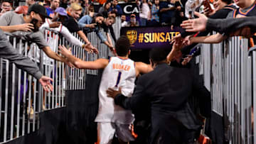 PHOENIX, AZ - JANUARY 7: Devin Booker #1 of the Phoenix Suns high fives fans after the game against the Oklahoma City Thunder on January 7, 2018 at Talking Stick Resort Arena in Phoenix, Arizona. NOTE TO USER: User expressly acknowledges and agrees that, by downloading and or using this photograph, user is consenting to the terms and conditions of the Getty Images License Agreement. Mandatory Copyright Notice: Copyright 2018 NBAE (Photo by Barry Gossage/NBAE via Getty Images)