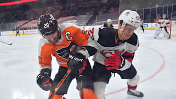 Mar 23, 2021; Philadelphia, Pennsylvania, USA; Philadelphia Flyers center Claude Giroux (28) and New Jersey Devils left wing Mikhail Maltsev (23) battle for the puck during the first period at Wells Fargo Center. Mandatory Credit: Eric Hartline-USA TODAY Sports