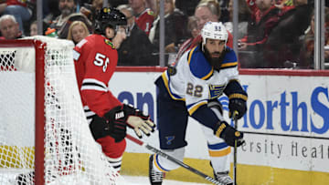 CHICAGO, IL - APRIL 06: Chris Thorburn #22 of the St. Louis Blues and Blake Hillman #55 of the Chicago Blackhawks watch the puck in the second period at the United Center on April 6, 2018 in Chicago, Illinois. (Photo by Bill Smith/NHLI via Getty Images)