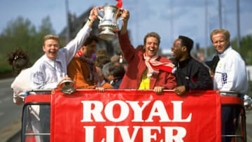 10 May 1992: (From left to right) David Burrows, Dean Saunders, Rob Jones, Mark Walters and Mark Wright of Liverpool stand on the top deck of the tour bus and celebrate as they hold the trophy aloft during their homecoming after their FA Cup Final victory against Sunderland at Wembley Stadium in London. Liverpool won the match 2-0. Mandatory Credit: Mike Hewitt/Allsport