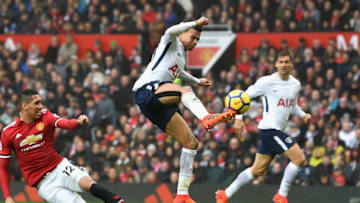 MANCHESTER, UNITED KINGDOM - OCTOBER 28: Dele Alli of Tottenham Hotspur shoots as Chris Smalling of Manchester United attempts to tackle during the Premier League match between Manchester United and Tottenham Hotspur at Old Trafford on October 28, 2017 in Manchester, England. (Photo by Michael Regan/Getty Images)