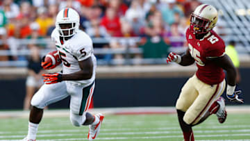 CHESTNUT HILL, MA - SEPTEMBER 01: Mike James #5 of the Miami Hurricanes is pursued by Josh Keyes #25 of the Boston College Eagles after catching a pass during the game on September 1, 2012 at Alumni Stadium in Chestnut Hill, Massachusetts. (Photo by Jared Wickerham/Getty Images)
