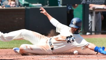 KANSAS CITY, MO - MAY 6: Whit Merrifield #15 of the Kansas City Royals slides across home to score on a Mike Moustakas sacrifice fly in the first inning against the Detroit Tigers at Kauffman Stadium on May 6, 2018 in Kansas City, Missouri. (Photo by Ed Zurga/Getty Images)