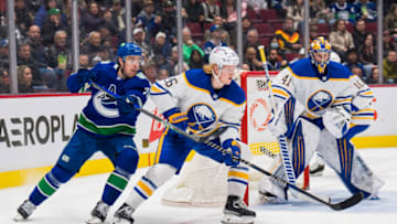Mar 20, 2022; Vancouver, British Columbia, CAN; Vancouver Canucks forward Tanner Pearson (70) stick checks Buffalo Sabres defenseman Rasmus Dahlin (26) in the third period at Rogers Arena. Sabres won 3-2 in overtime. Mandatory Credit: Bob Frid-USA TODAY Sports