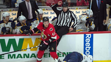 Nov 5, 2016; Ottawa, Ontario, CAN; Buffalo Sabres center Derek Grant (27) is checked by Ottawa Senators right wing Mark Stone (61) in the third period at the Canadian Tire Centre. The Sabres defeated the Senators 2-1. Mandatory Credit: Marc DesRosiers-USA TODAY Sports
