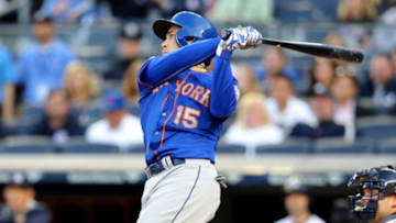 May 13, 2014; Bronx, NY, USA; New York Mets catcher Travis d'Arnaud (15) bats against the New York Yankees during a game at Yankee Stadium. Mandatory Credit: Brad Penner-USA TODAY Sports