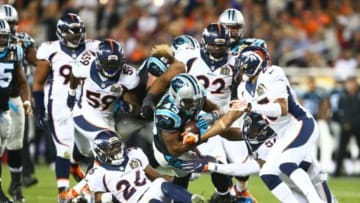 Feb 7, 2016; Santa Clara, CA, USA; Carolina Panthers running back Fozzy Whittaker (43) is tackled by members of the Denver Broncos defense in the third quarter in Super Bowl 50 at Levi